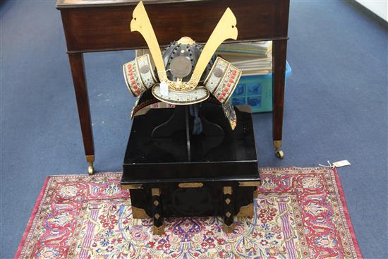 Japanese movie interest: A reproduction of a Japanese Samurai helmet (Kabuto), with ebonised box, helmet approximately 41.5cm wide